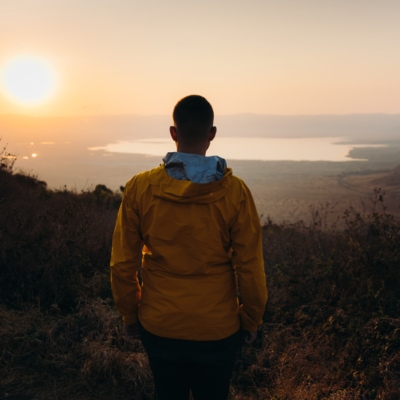 Male Traveler Contemplating The Scenic Sunrise Above Ngorongoro Volcano Crater In Tanzania